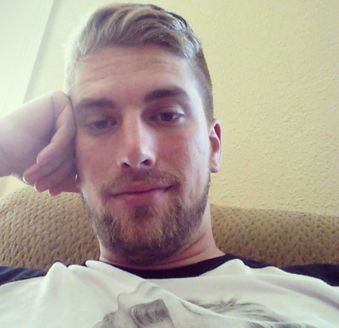 Steve resting his head on his hand on a couch